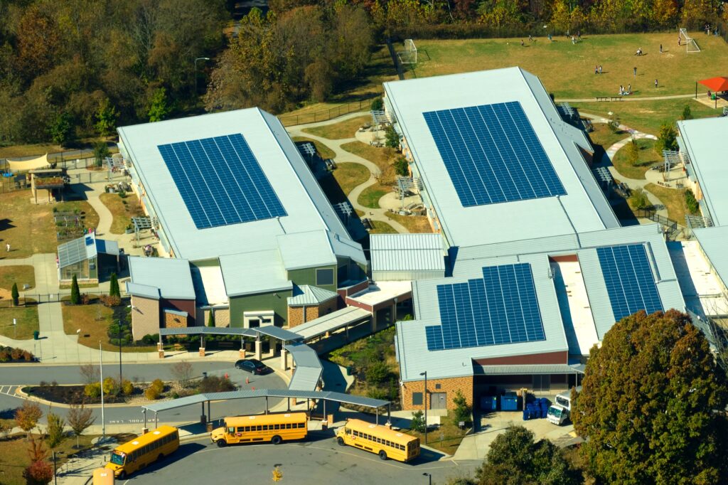 Roof of american school building covered with photovoltaic solar panels